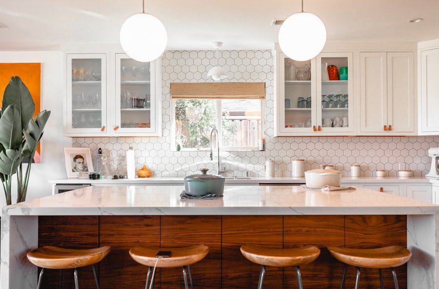 Kitchen island with wood cabinetry and marble counter